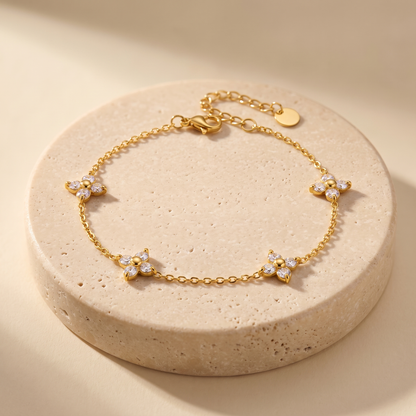 Alba Clover Station Bracelet displayed on travertine