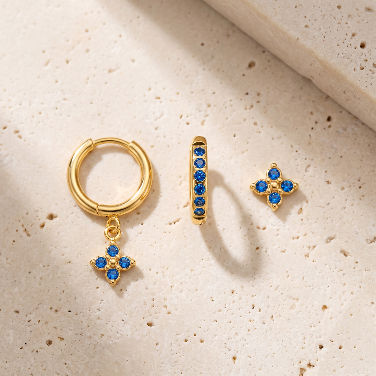 Myrtle Clover Stack Earrings in Blue on travertine