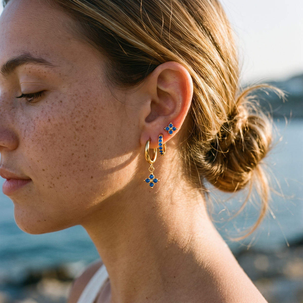 Myrtle Clover Stack Earrings in Blue close-up on the ear