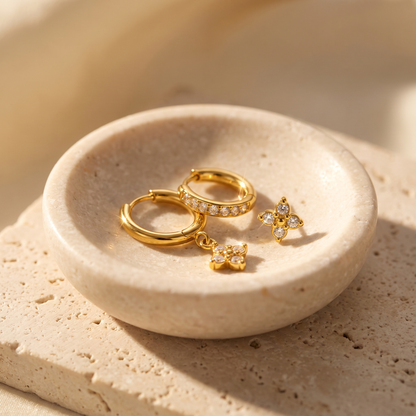 Myrtle Clover Stack Earrings in Clear displayed on travertine