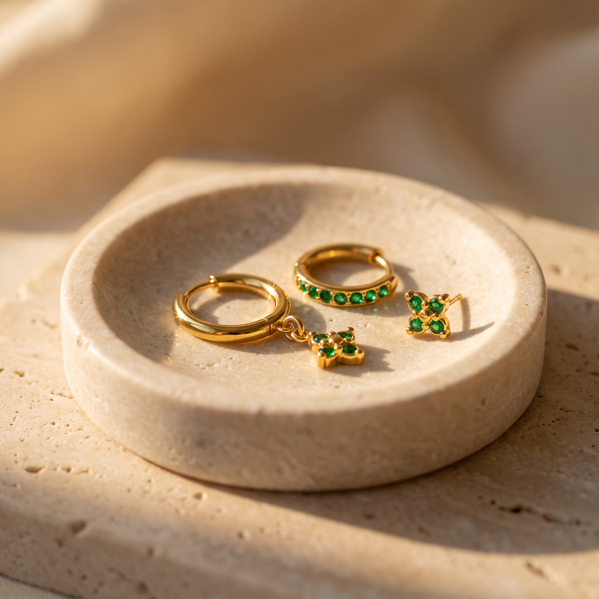 Myrtle Clover Stack Earrings in Green displayed on travertine