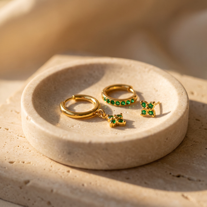 Myrtle Clover Stack Earrings in Green displayed on travertine